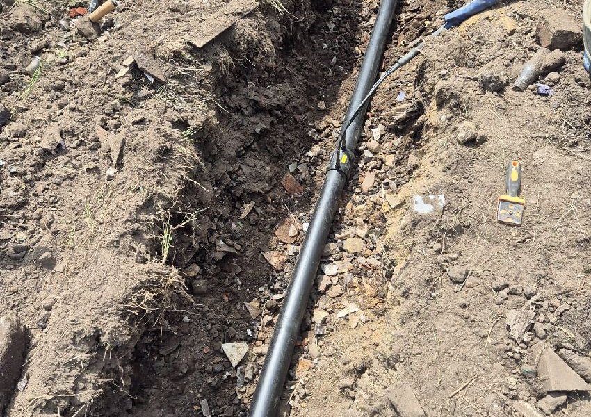New black 90 mm pipe laid in a trench