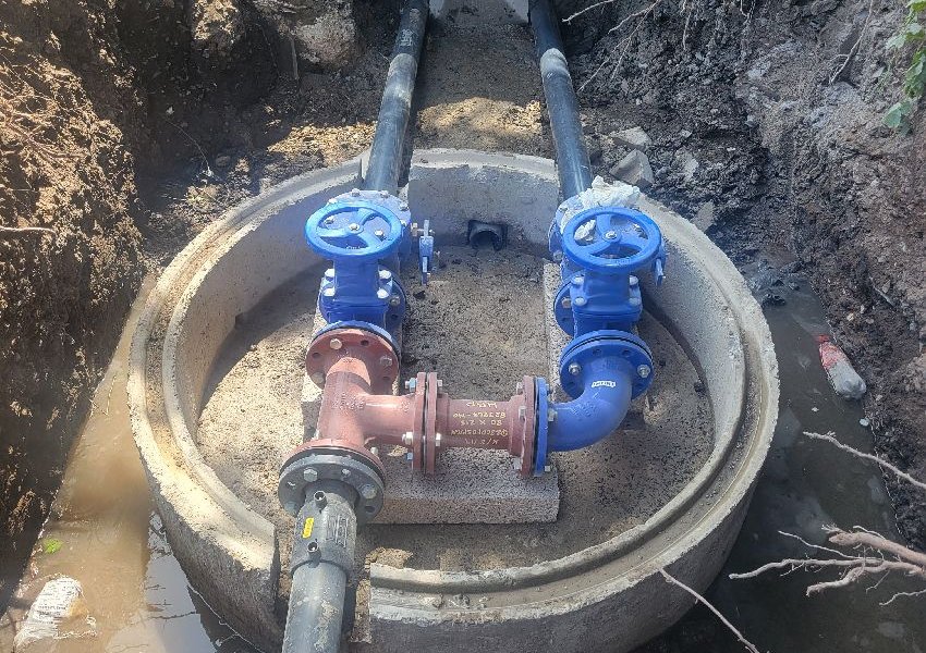 New valve chamber with non-return and gate valves beside a new pump chamber near Bagshot