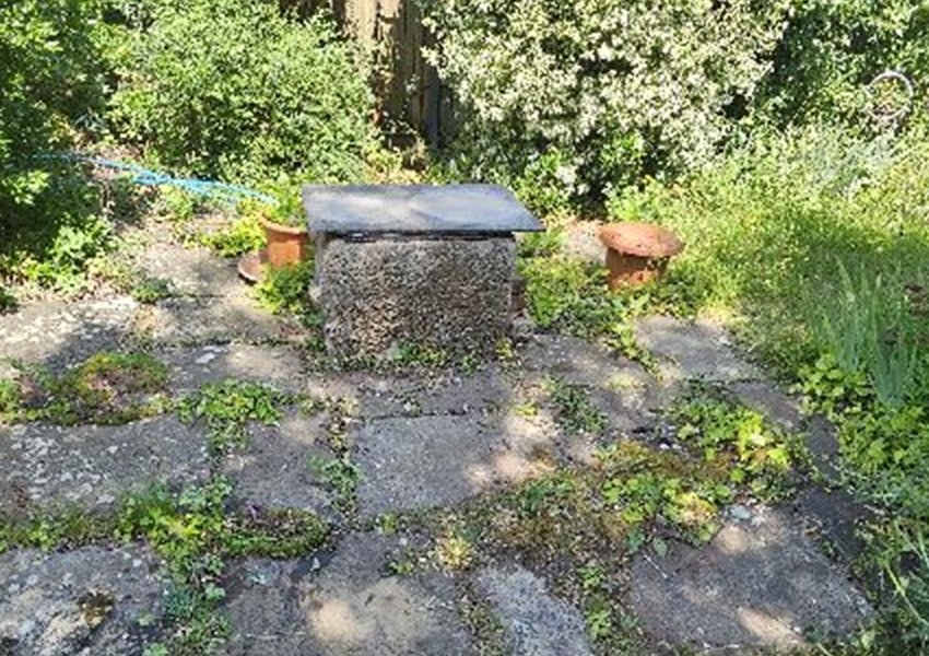 Borehole cover in a garden near Farnham