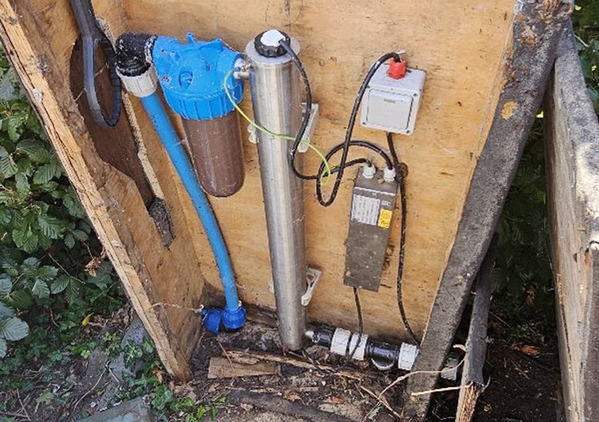 Water filter and ultraviolet treatment unit in a cabinet on a private borehole supply near Farnham