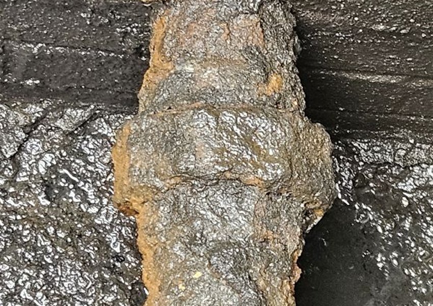 Badly corroded pipework inside a valve chamber