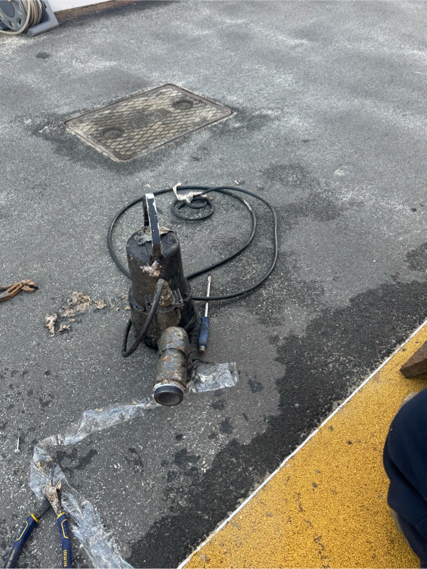 Removed submersible pump beside the Surrey school pump-station chamber