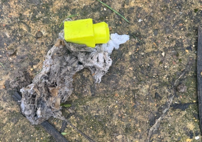 Rag and wipes next to a yellow float switch after being removed from a pump