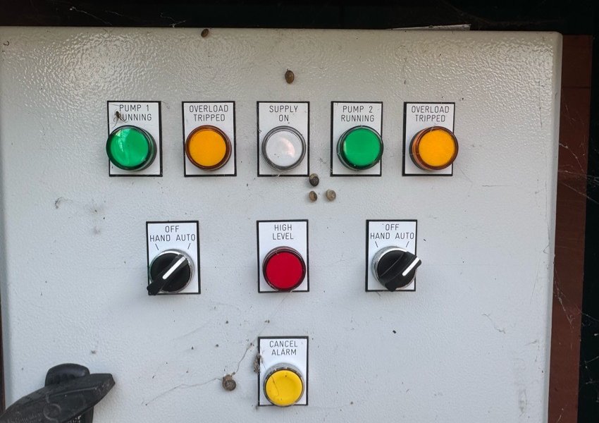 Pump control panel with status lights, hand-off-auto switches and a high-level light