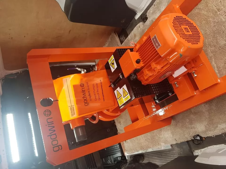 New orange Godwin pump on a wooden pallet
