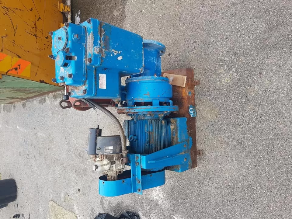 Old blue pump on a metal base plate