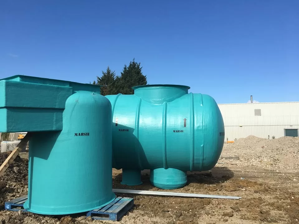 A teal Marsh Ensign package pump station unit on a pallet at a construction site in Tonbridge