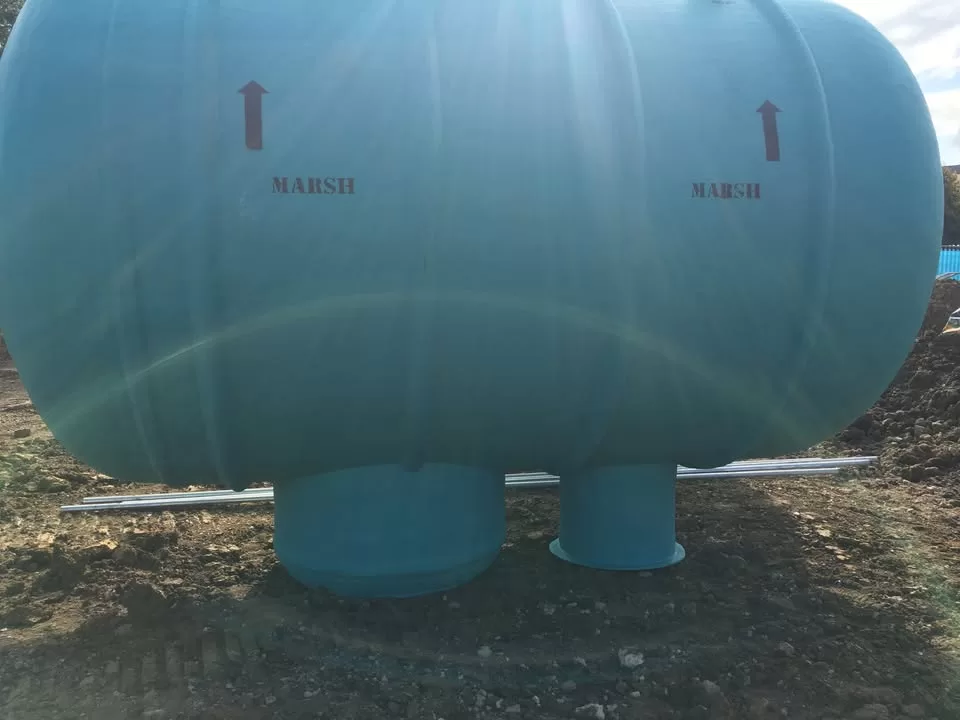A close-up of the Marsh Ensign tank with directional arrows printed on the surface