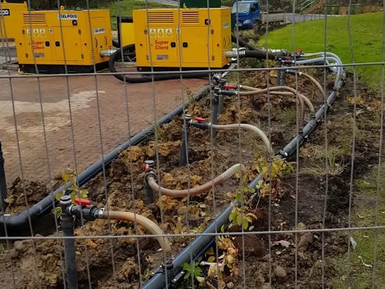Yellow generators and pipework installed for dewatering a pump station chamber in Southampton