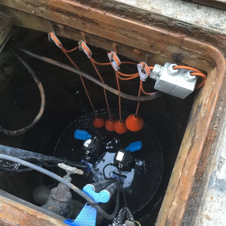 Close-up of float switches and junction box inside the pump station
