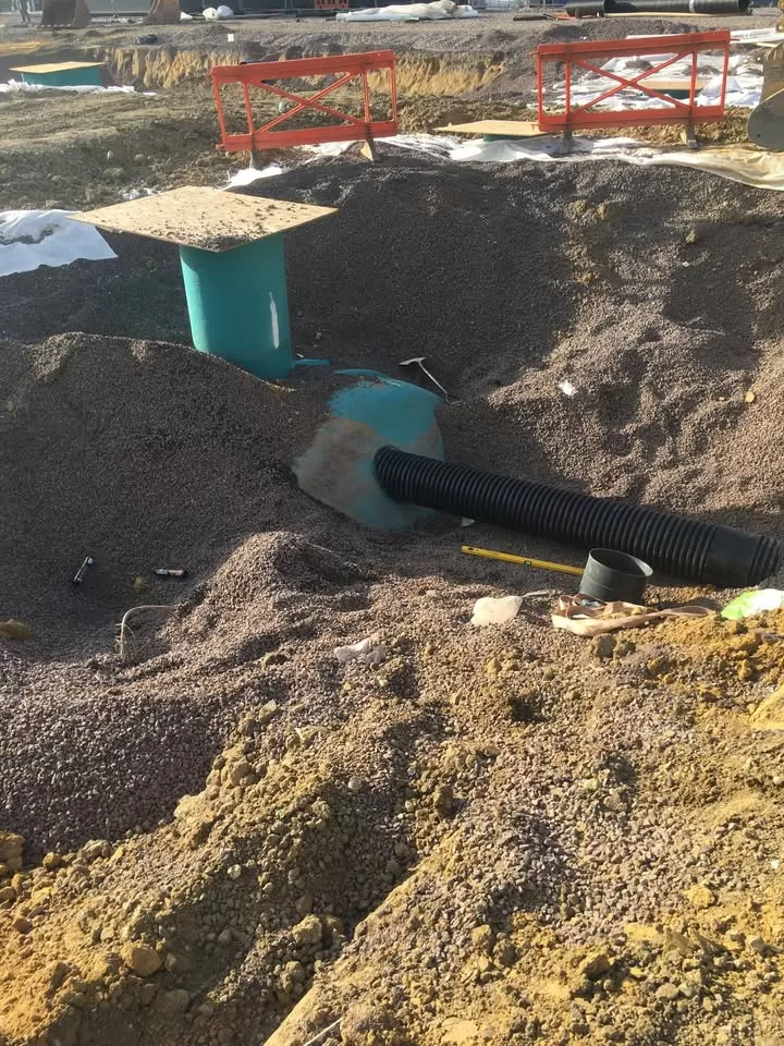 Rainwater harvesting tank with pipework connections visible during installation