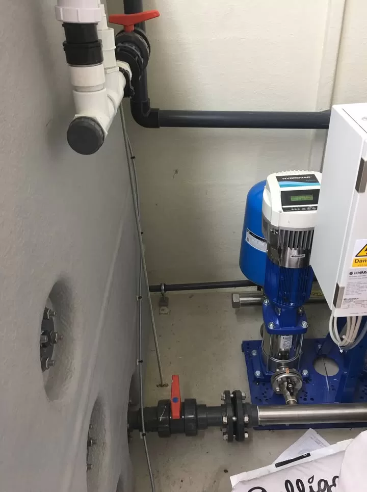 Pump room showing booster pump unit and control panel installed for the rainwater system